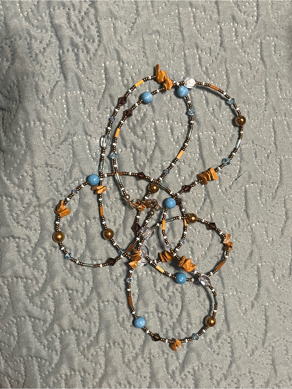 Beaded  neckless with Blue and Gold Accents long can be doubled to 25”